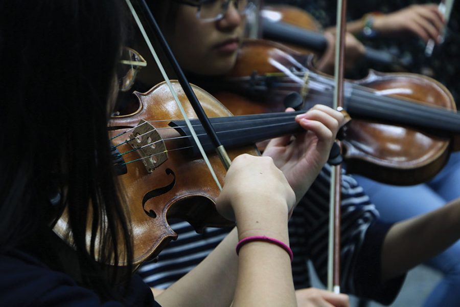 Sophomore Joanna Lee plays the violin during Symphony Orchestra. She said that although her brother was also a musician, orchestra is one way she is able to stand out from her brother who participated in band.