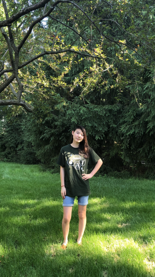 Karolena Zhou, staff member and sophomore, poses in her yard. Zhou said being an only child has made her who she is today and she doesnt want to change that.