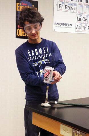 Senior Yannik Singh works on a chemistry experiment during Chemistry Club afterschool. In addition to the club, he also participates in Chemistry Olympiad.