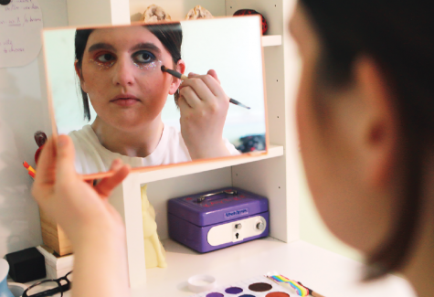 Sophomore Kaylee Gingo does her makeup in the mirror, incorporating bright colors to show her pride. She said, “There are some stereotypes that I find in the clothes I wear but otherwise my identity doesn’t really affect my expression.
