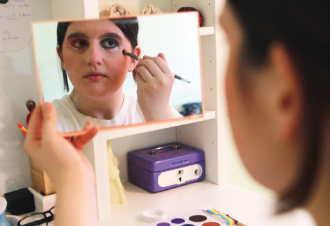 Sophomore Kaylee Gingo does her makeup in the mirror, incorporating bright colors to show her pride. She said, “There are some stereotypes that I find in the clothes I wear but otherwise my identity doesn’t really affect my expression."