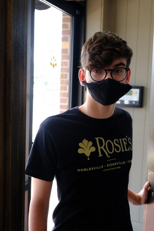 Sophomore Michael Morfas enters work at Rosie’s. He said student employment is important for a sense of independence. 