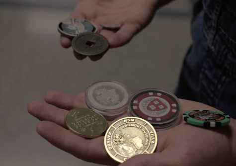 Senior Alex Rushinksy shows some of his coins which he collects. Rushinsky said the Philmont coin, shown in the photo is from New Mexico.