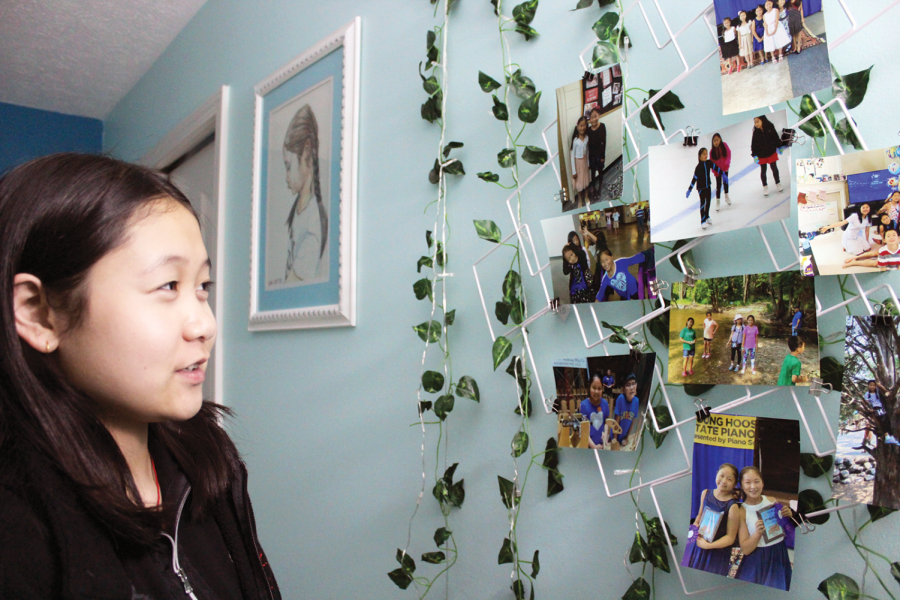 Freshman Helena Wang displays photographs that are hung up on her bedroom wall on February 8, 2022. She said she thinks she has always been mature for her age. 