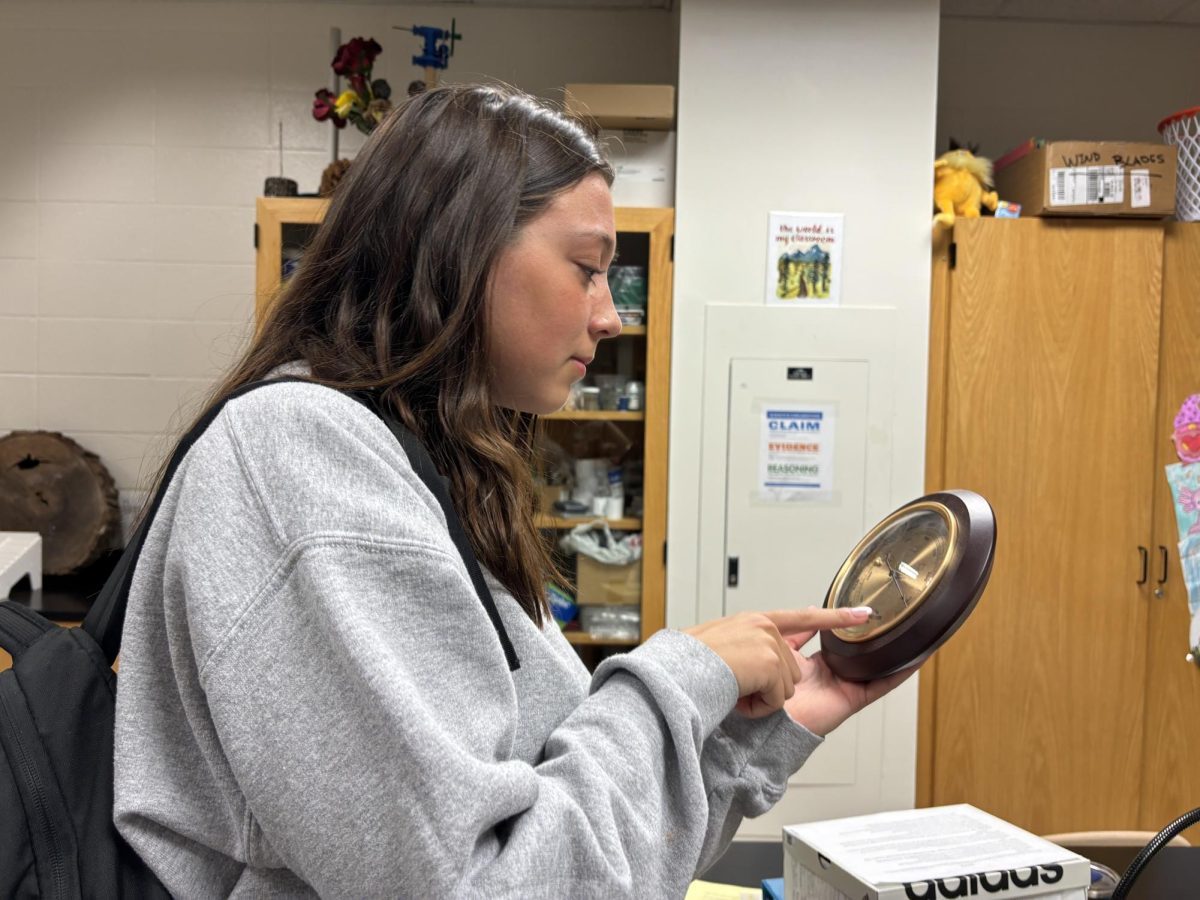 Junior Jossy Visser examines meteorological instruments from her Advanced Science Meteorology class.