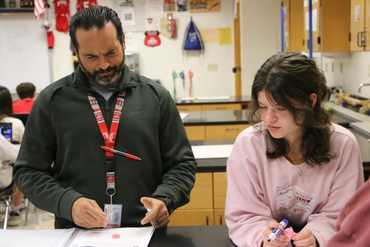 AP physics teacher Jeremy Stacy assists students in class about their current class work. Stacy said he makes sure that his students feel comfortable in an educational setting.