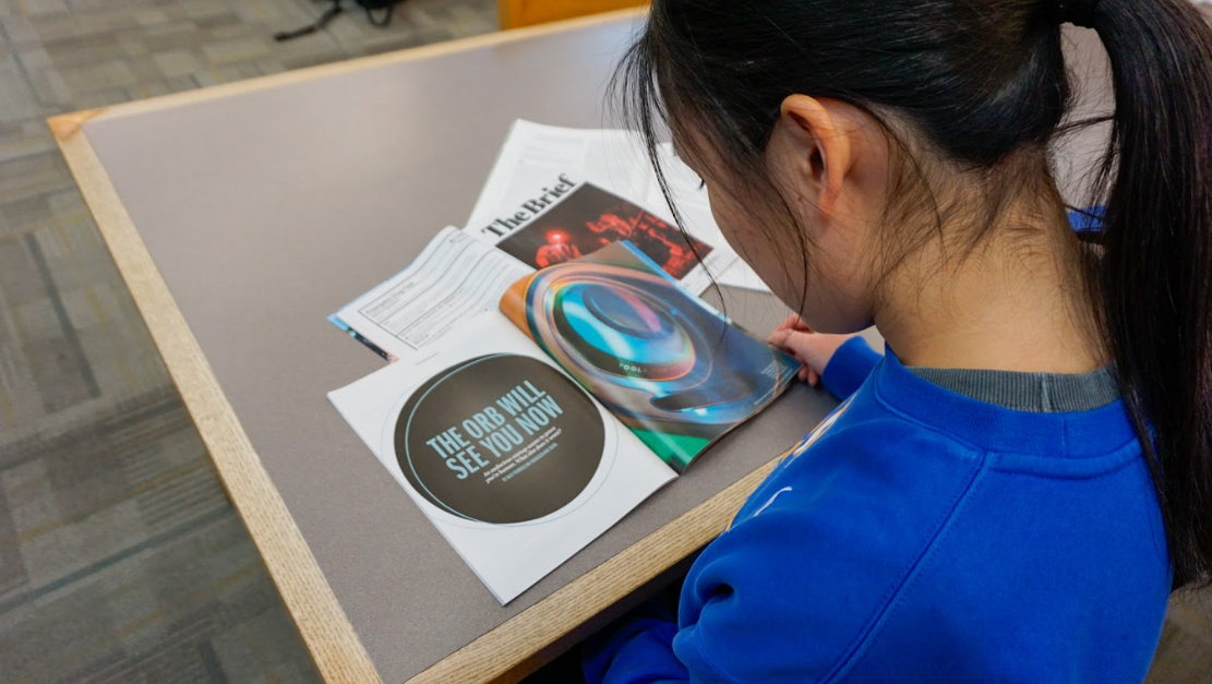 Senior Hillary Yang reads issues of TIME magazine. Yang said, despite positive efforts with artificial intelligence, it still poses an ethical threat to creative disciplines like journalism. 